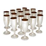 A matched set of sixteen Asprey & Co. silver champagne flutes, comprising nine examples hallmarked