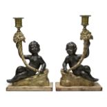 A pair of Regency gilt and black painted plaster candlesticks, early 19th century, in the form of