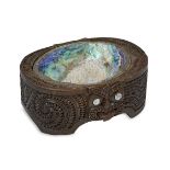 A Māori carved wood box, inset with abalone shell and carved with scrolls and notches, the front and