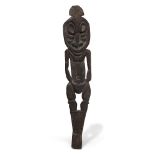 A Sepik ancestral figure, New Guinea, 20th century, of stylised figural form, with carved decoration