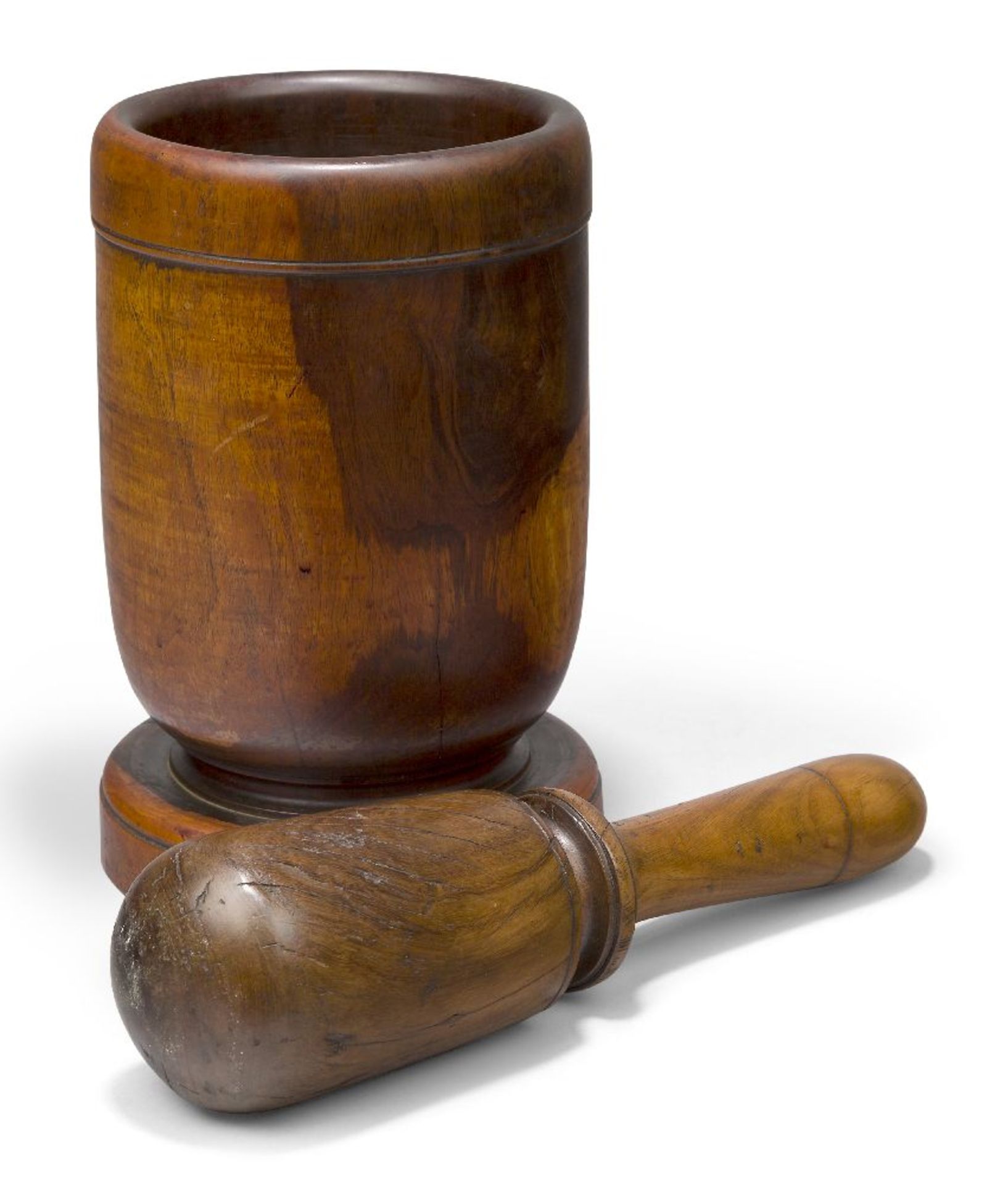 A turned lignum vitae mortar and pestle, late 18th century, of cylindrical form, 23cm highThe pestle