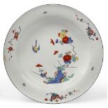 A Meissen large Kakiemon dish, c.1730, blue crossed sword mark, painted in the Kakiemon palette