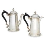 A pair of Edwardian silver café-au-lait pots, London, c.1907 and 1908, Marples & Co., of tapering