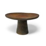 A Senufo low table, Ivory Coast, 20th century, the circular dished top with carved geometric