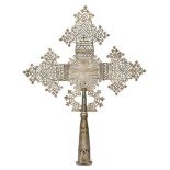 A large Ethiopian Coptic silvered bronze processional cross, probably 19th century, with typical