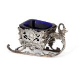 A silver salt designed as a sleigh, with blue glass liner supported by an openwork mount, London