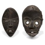 A Dan mask, Ivory Coast, 20th Century, of oval form with carved stylised features, 23cm high,