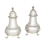 A pair of silver sugar casters, London, c.1961, Harrods, the baluster-shaped bodies raised on paw