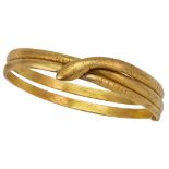 A double row bangle of serpent design, with engraved scale detail and crossover head, unmarked,