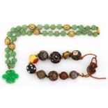 A carved jadeite jade bead necklace and an oriental bead bracelet, the necklace composed of carved