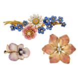 Three early 20th century diamond and vari-coloured enamel brooches, one designed as a floral spray