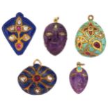 Five Indian gem-set pendants: two composed of carved amethyst masks embelished with lasque-cut