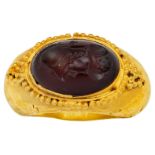 A carnelian intaglio ring, in the Roman style, set with an oval carnelian intaglio depicting the