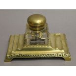 A brass inkwell. 19 cm wide.