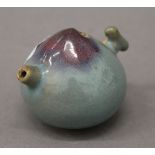 A Chinese purple splash pottery water dropper. 5 cm high.