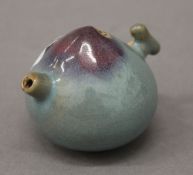 A Chinese purple splash pottery water dropper. 5 cm high.