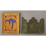 A 19th century Russian carved wooden icon dated 1864 and an 18th century bronze folding icon of