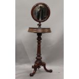 A Victorian mahogany shaving stand, with original mirror. 132 cm high.