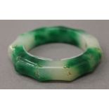 A jade faux bamboo bangle. 8 cm diameter.