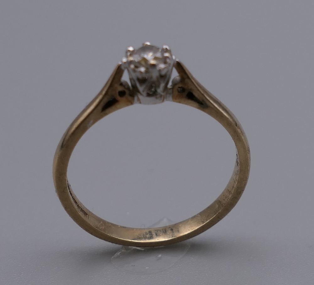 A 9 ct gold diamond solitaire ring. Ring Size N/O. 2.1 grammes total weight. - Image 2 of 3