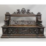 A 19th century carved walnut settle. 180 cm wide.