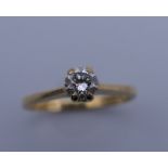 An 18 ct gold diamond solitaire ring. Ring size G/H. 1.8 grammes total weight.