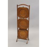 An early 20th century mahogany folding cake stand. 87 cm high.