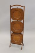 An early 20th century mahogany folding cake stand. 87 cm high.
