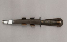 A Commando dagger in leather sheath. 32 cm high overall.