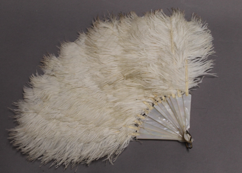 A vintage ostrich feather and mother-of-pearl fan. 38 cm long.