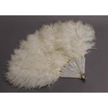 A vintage ostrich feather and mother-of-pearl fan. 38 cm long.