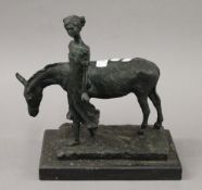 An abstract bronze model of a girl and donkey. 33 cm high.