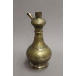 An antique brass bottle shaped hookah base with fine foliate overall decoration. 33.5 cm high.