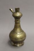 An antique brass bottle shaped hookah base with fine foliate overall decoration. 33.5 cm high.