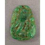 A carved green jade pendant. 5 cm high.