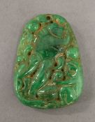 A carved green jade pendant. 5 cm high.