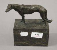 A bronze model of a greyhound on a plinth base. 15 cm high.