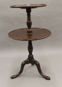 An Edwardian two-tier mahogany dumb waiter. 93 cm high.