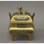 A vintage Chinese twin handled brass censer and cover, with dog finial and enamelled panels. 13.