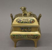 A vintage Chinese twin handled brass censer and cover, with dog finial and enamelled panels. 13.