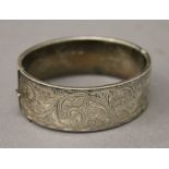 A silver hallmarked engraved bangle. 6.5 cm wide. 29 grammes.