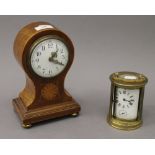 An Edwardian mahogany inlaid mantle clock and a carriage clock. The former 22 cm high.