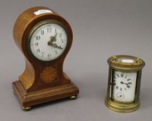 An Edwardian mahogany inlaid mantle clock and a carriage clock. The former 22 cm high.