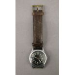 A WWII Waltham military watch. 3 cm wide.