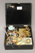 A Japanese lacquered box containing various costume jewellery, etc.