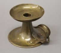 An Arts and Crafts brass chamberstick,