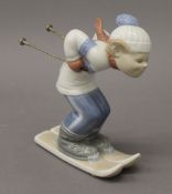 A Lladro figure of a skiing boy. 17.5 cm high.