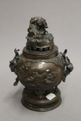 A 19th century Oriental patinated bronze incense burner and cover. 22 cm high.