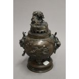 A 19th century Oriental patinated bronze incense burner and cover. 22 cm high.