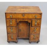 A Georgian walnut kneehole desk. 68 cm wide.